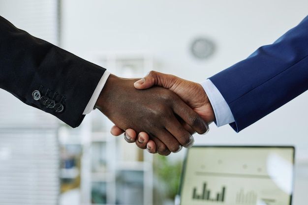 Premium-Photo-_-Close-up-of-two-business-people-shaking-hands-after-successful-partnership-negotiation-in-office-1.jpeg